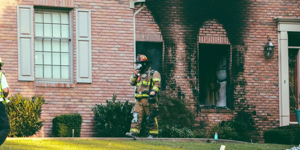 Severely fire-damaged home with charred walls and debris before professional cleanup and restoration.