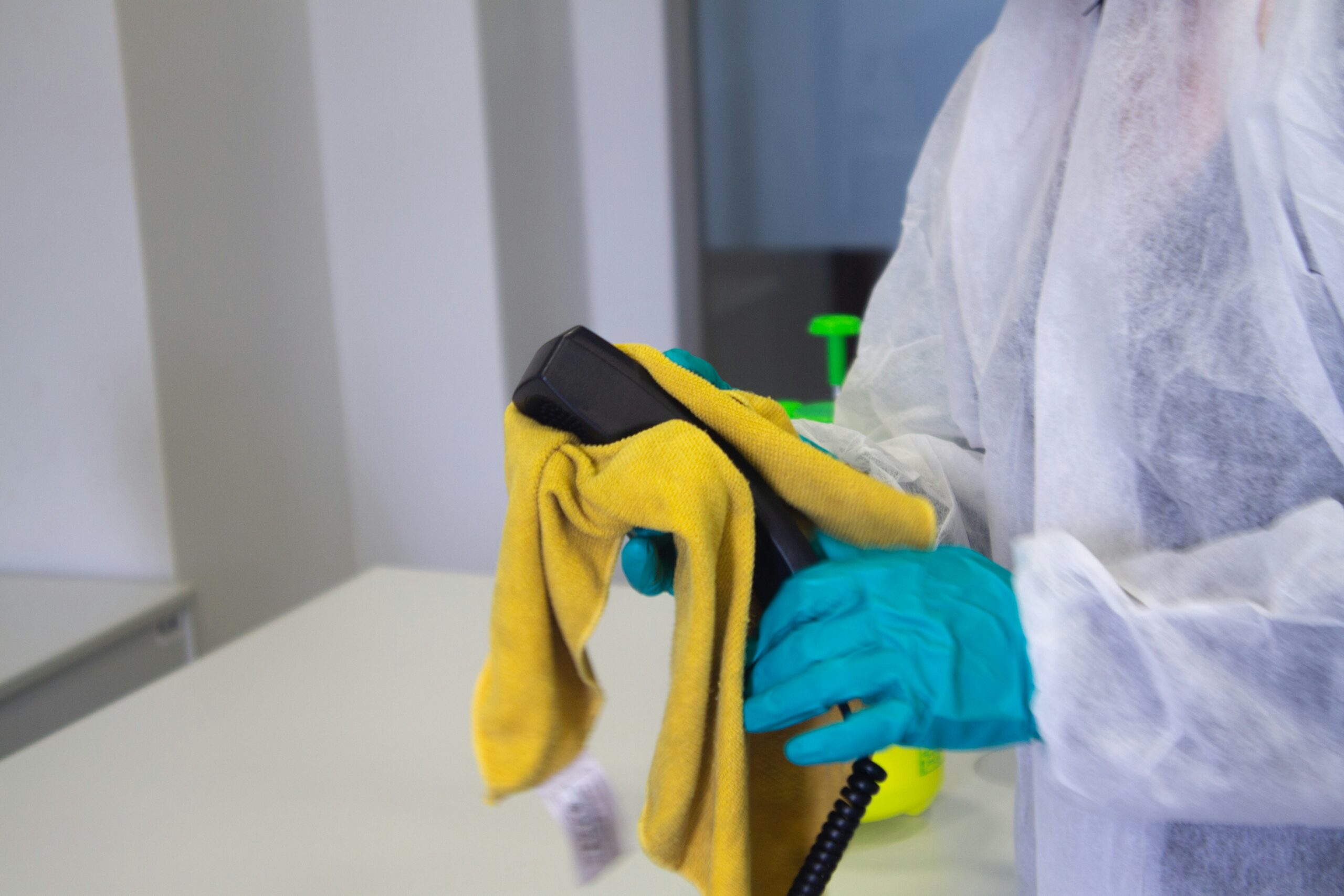 technician in protective gear removing mold at the source during professional mold remediation